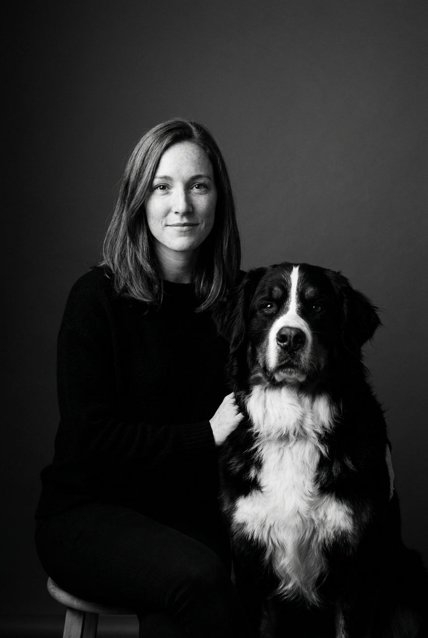 AI black and white studio portrait of a woman with her Bernese Mountain Dog